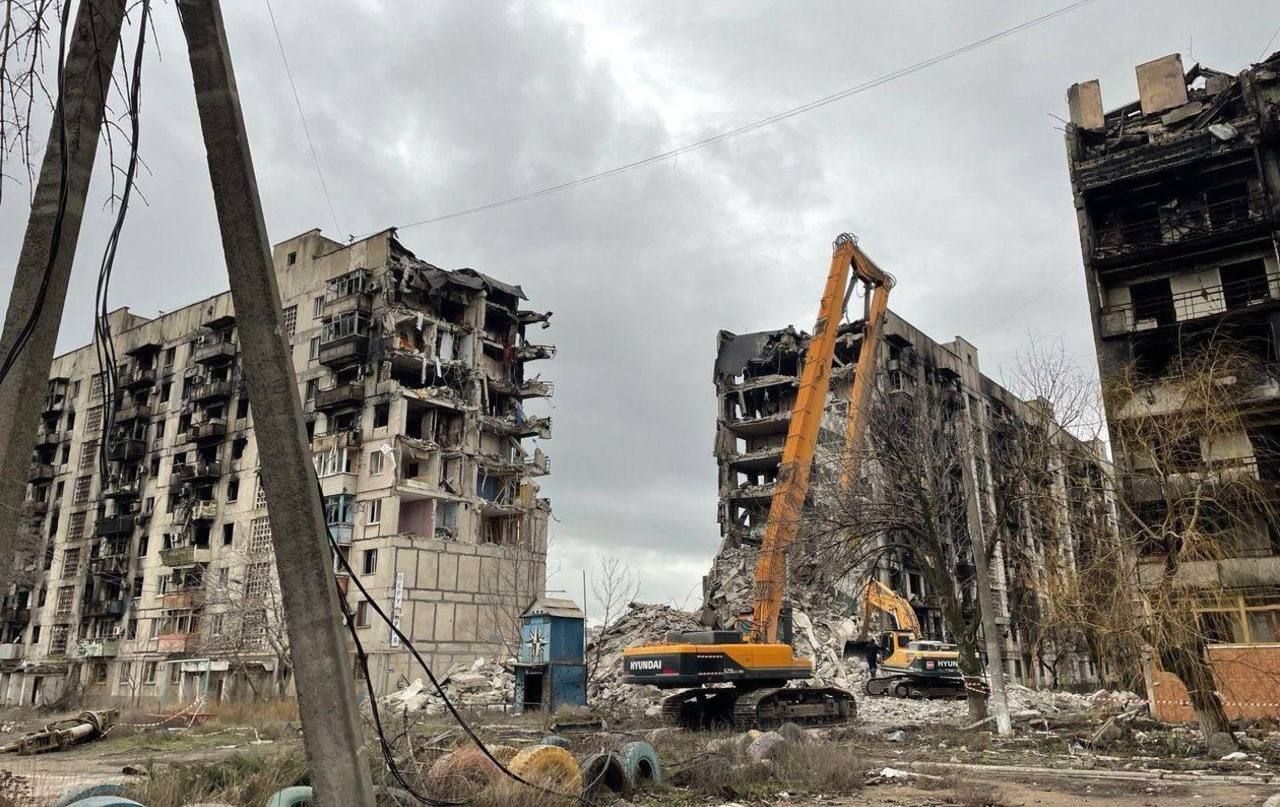 Destroyed apartment blocks being torn down in Mariupol