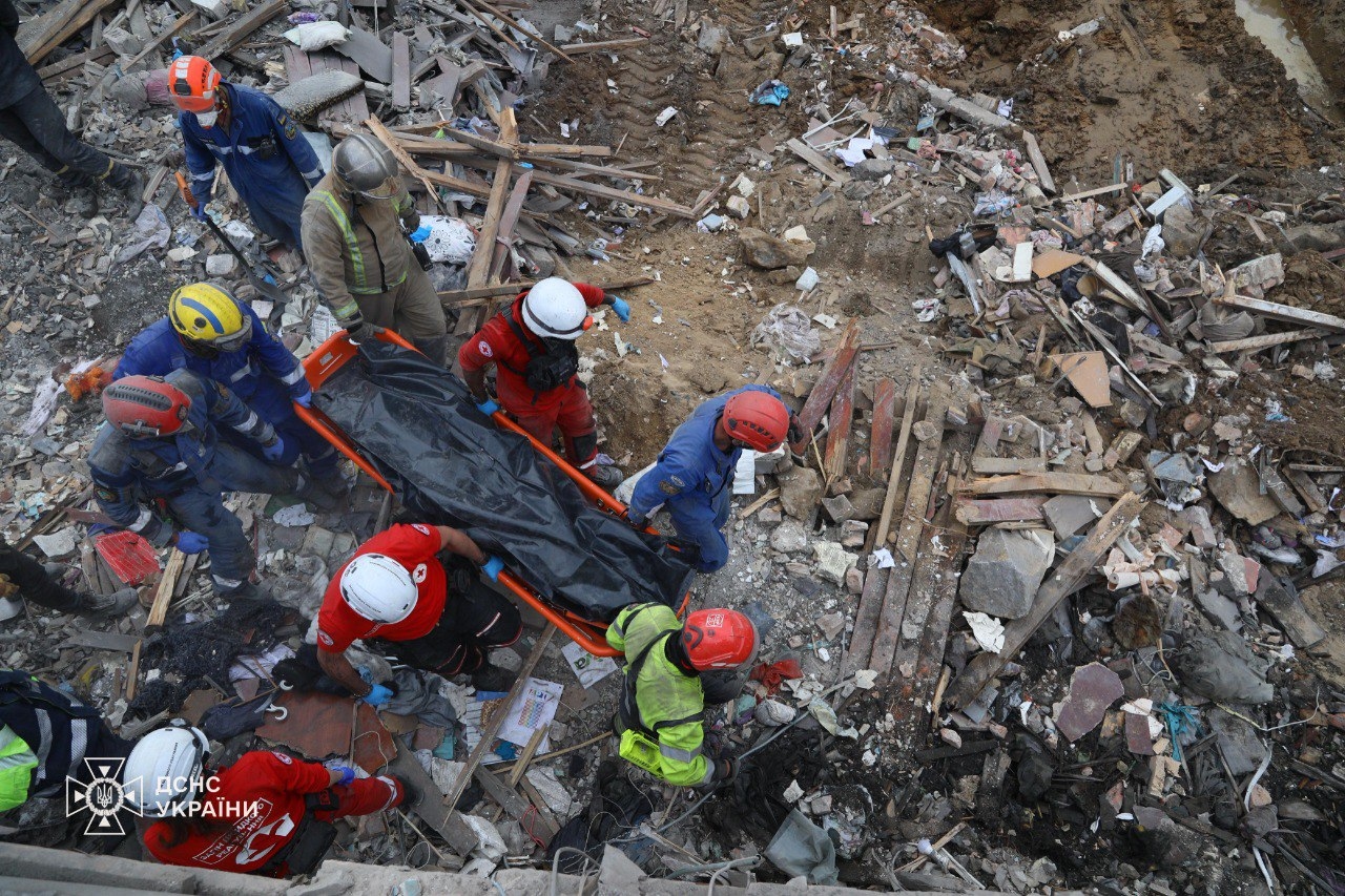 Emergency workers carrying a body pulled out from under the rubble of a building in Kyiv, Ukraine, on April 24.