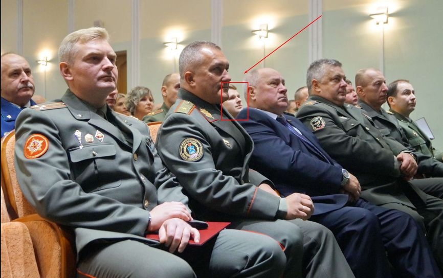 Aleksei Lobeev peeks out from behind the chin of GRU head Ruslan Kosygin