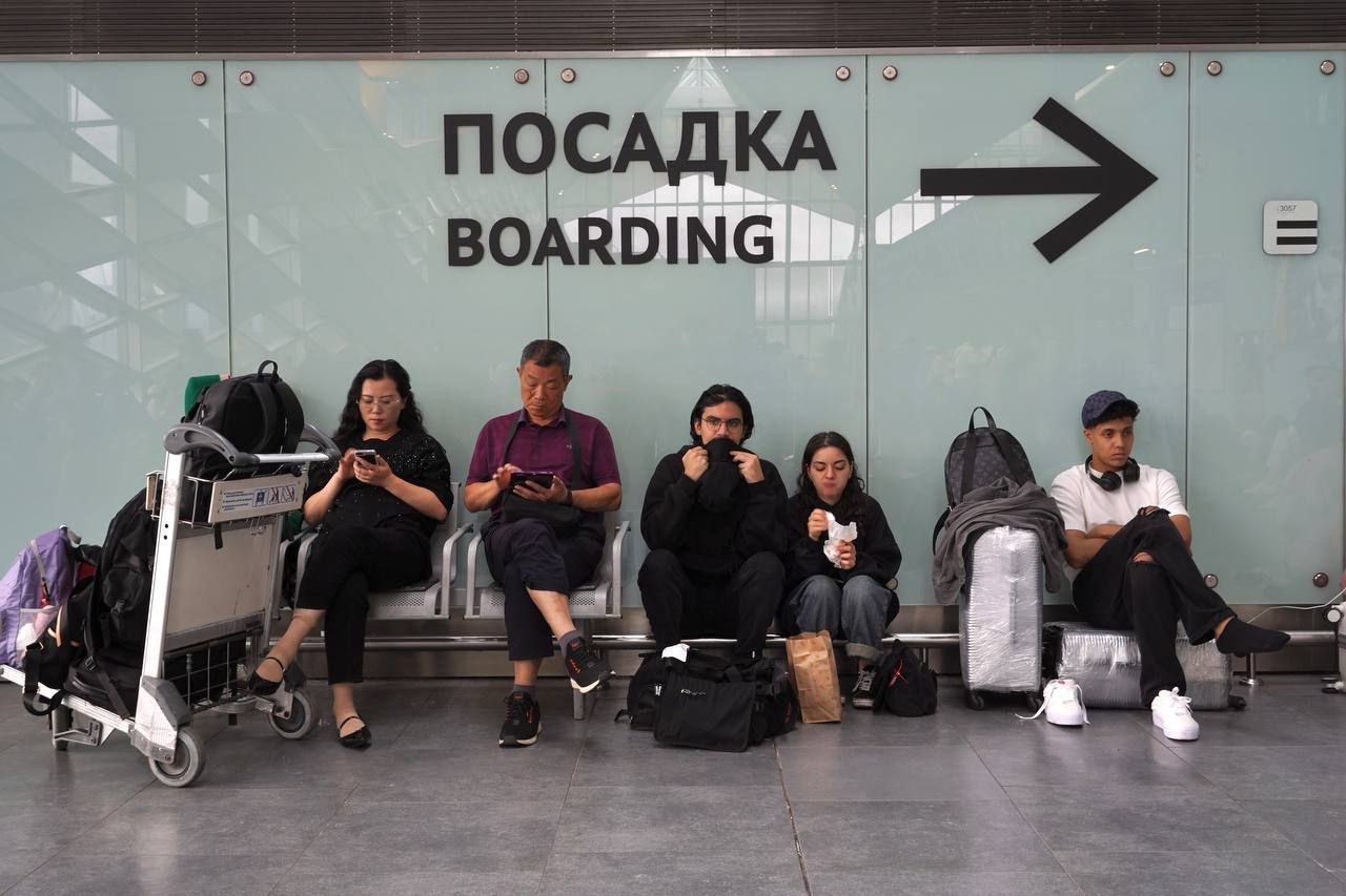 Passengers in a waiting area at Pulkovo Airport in St. Petersburg.