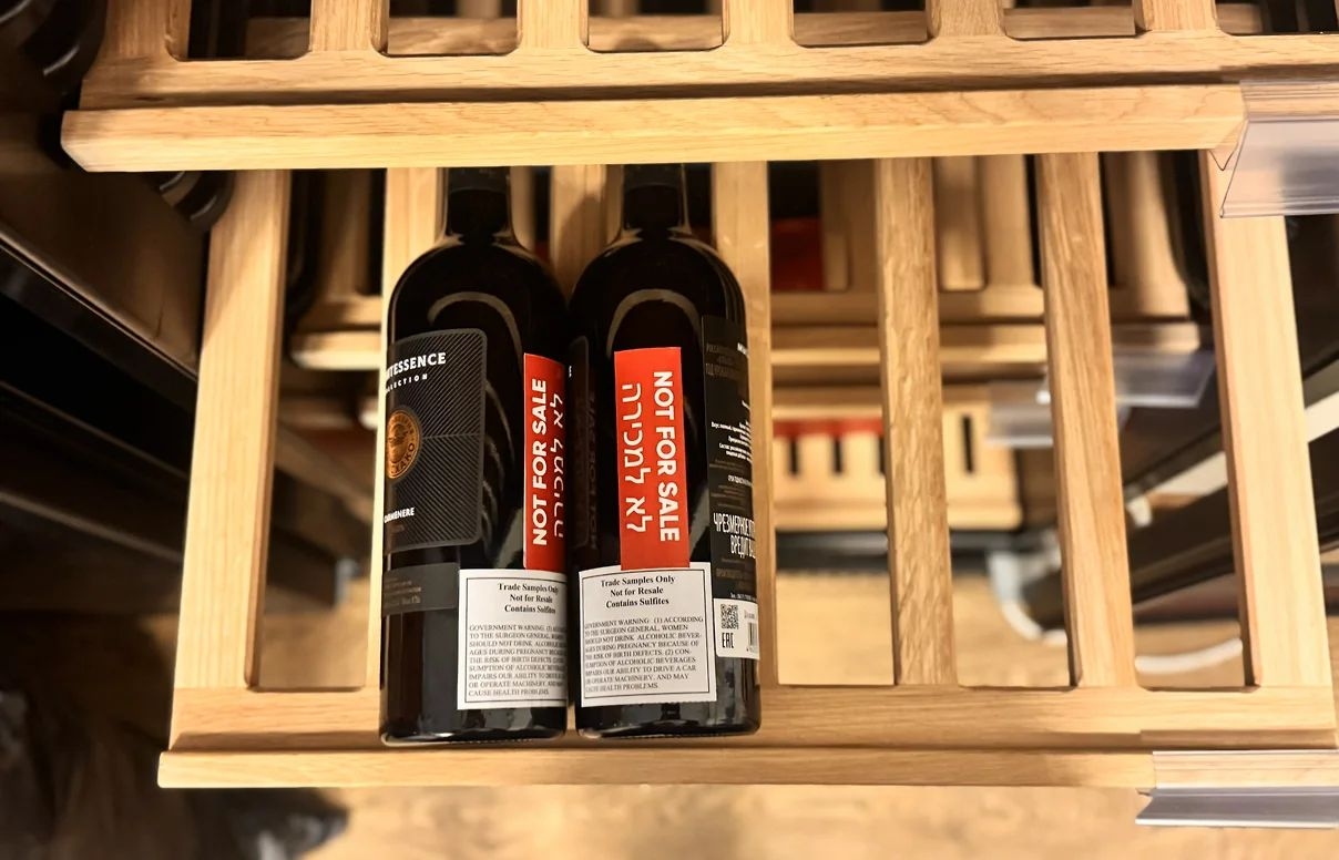 Examples of bottles with stickers in Hebrew reading “Not for sale” 