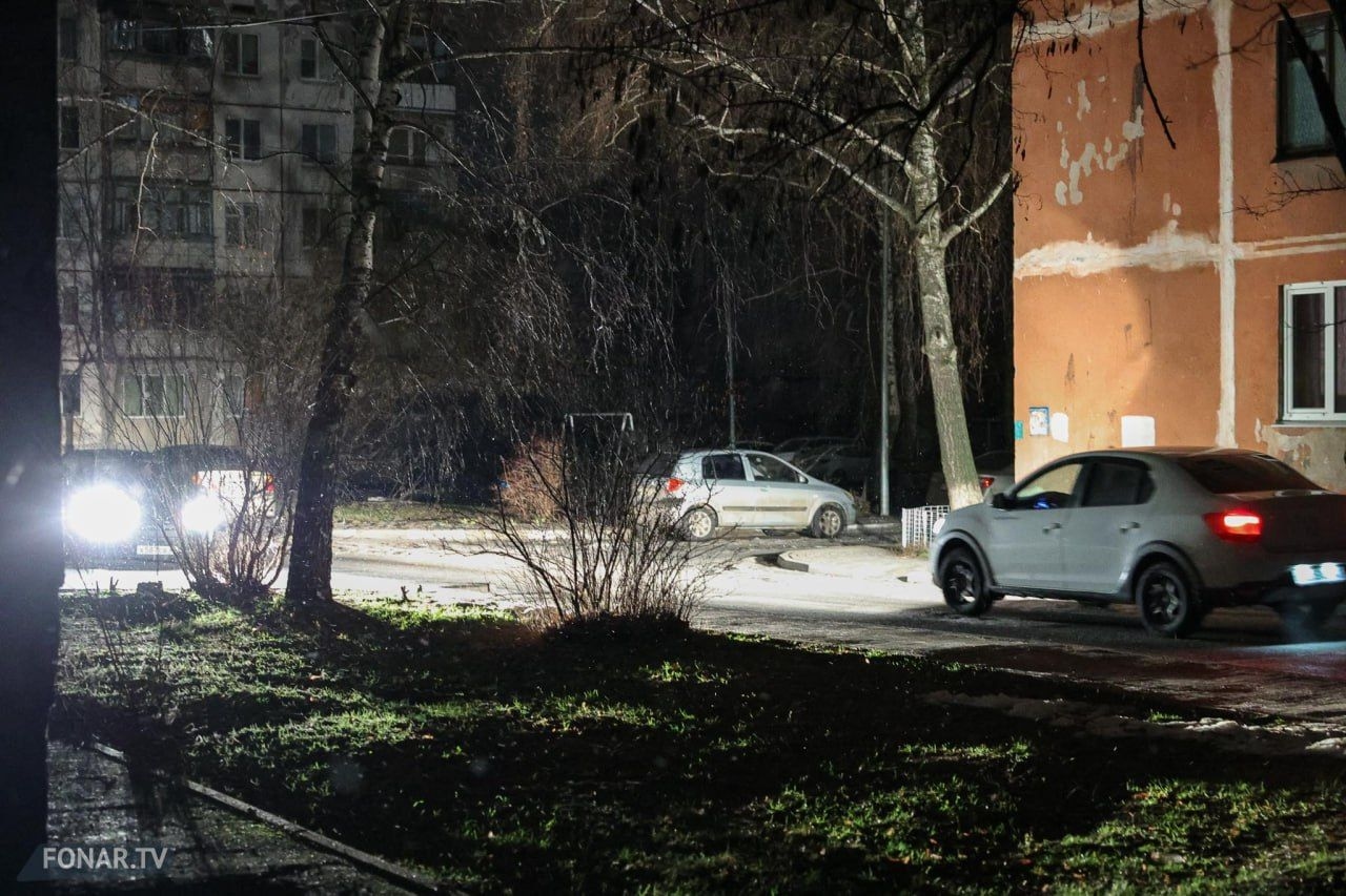 Cars light up a courtyard in one of Belgorod's residential areas during a blackout