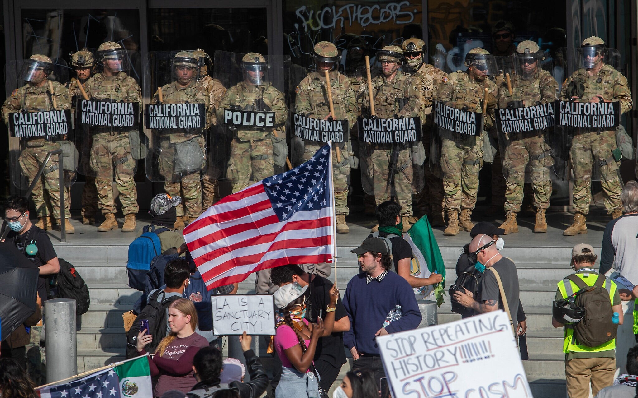 Demonstrators stand opposite members of the California National Guard outside the Federal Building on June 9, 2025. Photo: Apu Gomes / AP