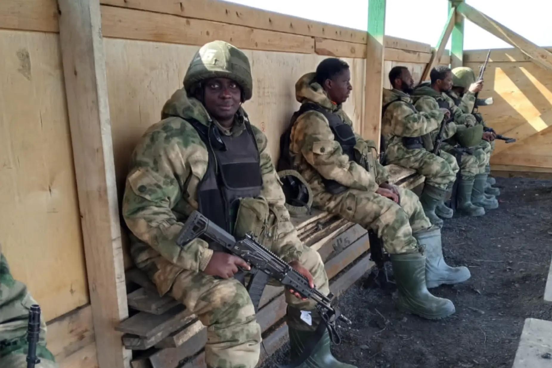 African recruits, including Ugandan citizens, wearing Russian military uniforms and holding rifles while deployed with Russian forces during the war in Ukraine. Photo: The Africa Report