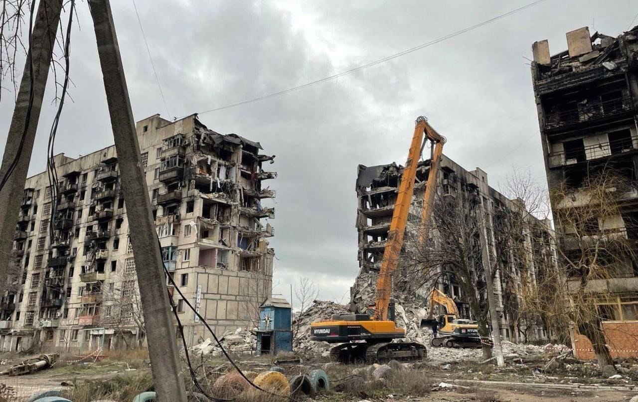 Destroyed apartment blocks being torn down in Mariupol