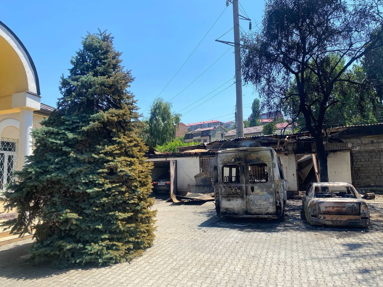Burnt-out cars in the cathedral yard