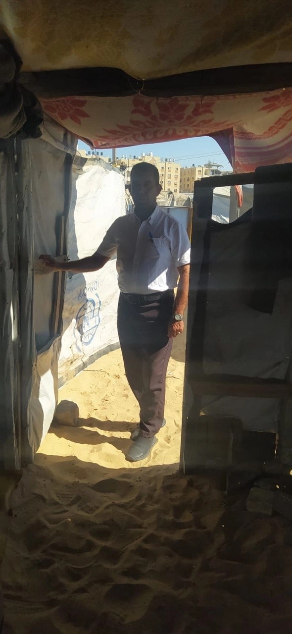 Nidal Abu Auda at the entrance to his tent