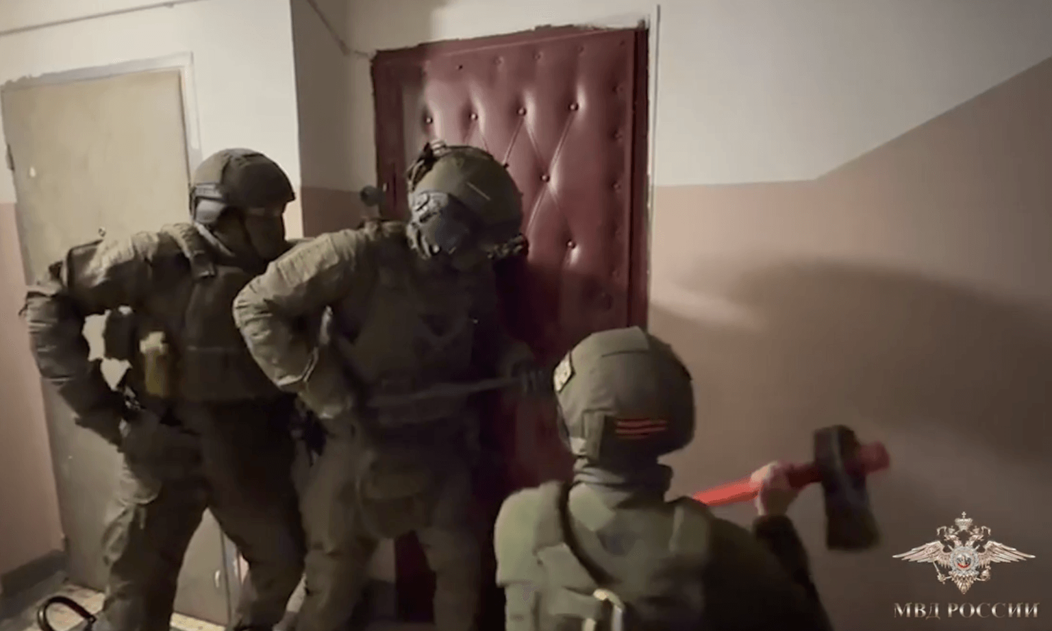 Raid on the apartment of a suspect accused of illegally sharing phone numbers with third parties. A still from a video by Russia's Ministry of Internal Affairs.