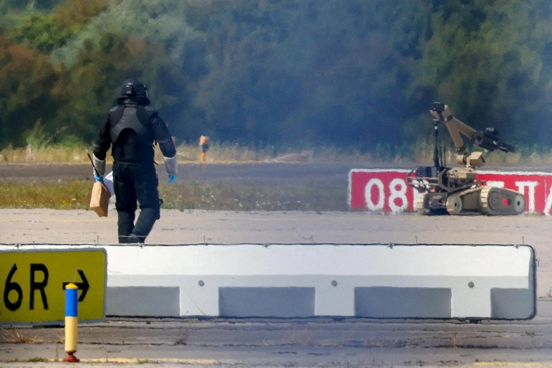 A police officer approaches a bomb disposal robot at Leipzig airport after a drone and a detonator were found near a Ukrainian transport plane in early August. Photo: Reuters / Axel Schmidt