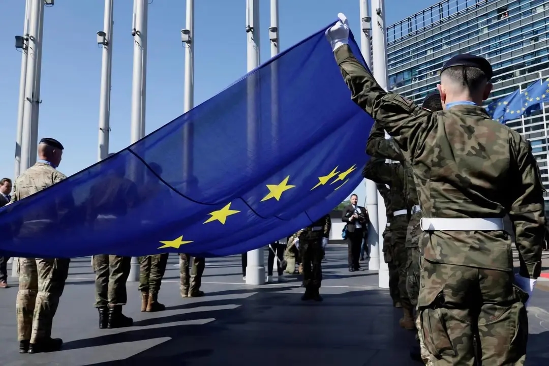 Eurocorps soldiers carrying a European Union flag during a flag-raising ceremony in front of the European Parliament building in Strasbourg, France. Photo: Ronald Wittek / EPA-EFE