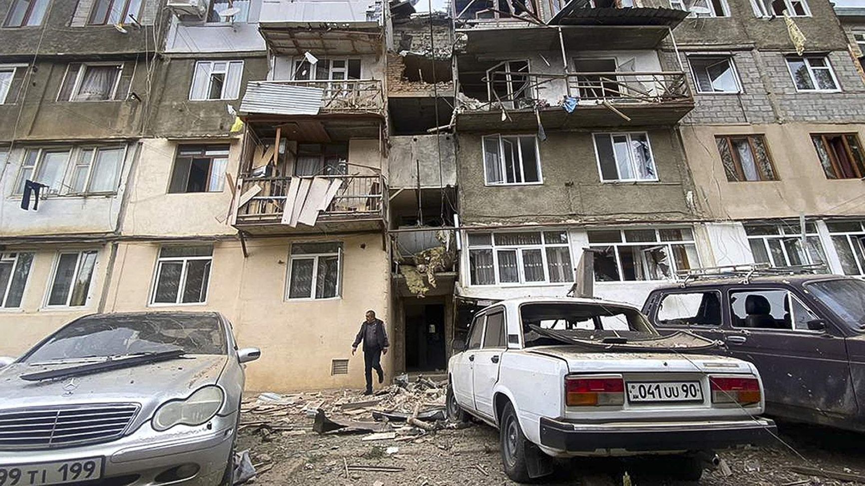 A view of a damaged apartment building and cars after the start of a military operation by Azerbaijani armed forces in the ethnic Armenian town of Stepanakert in Nagorno-Karabakh, September 19, 2023.