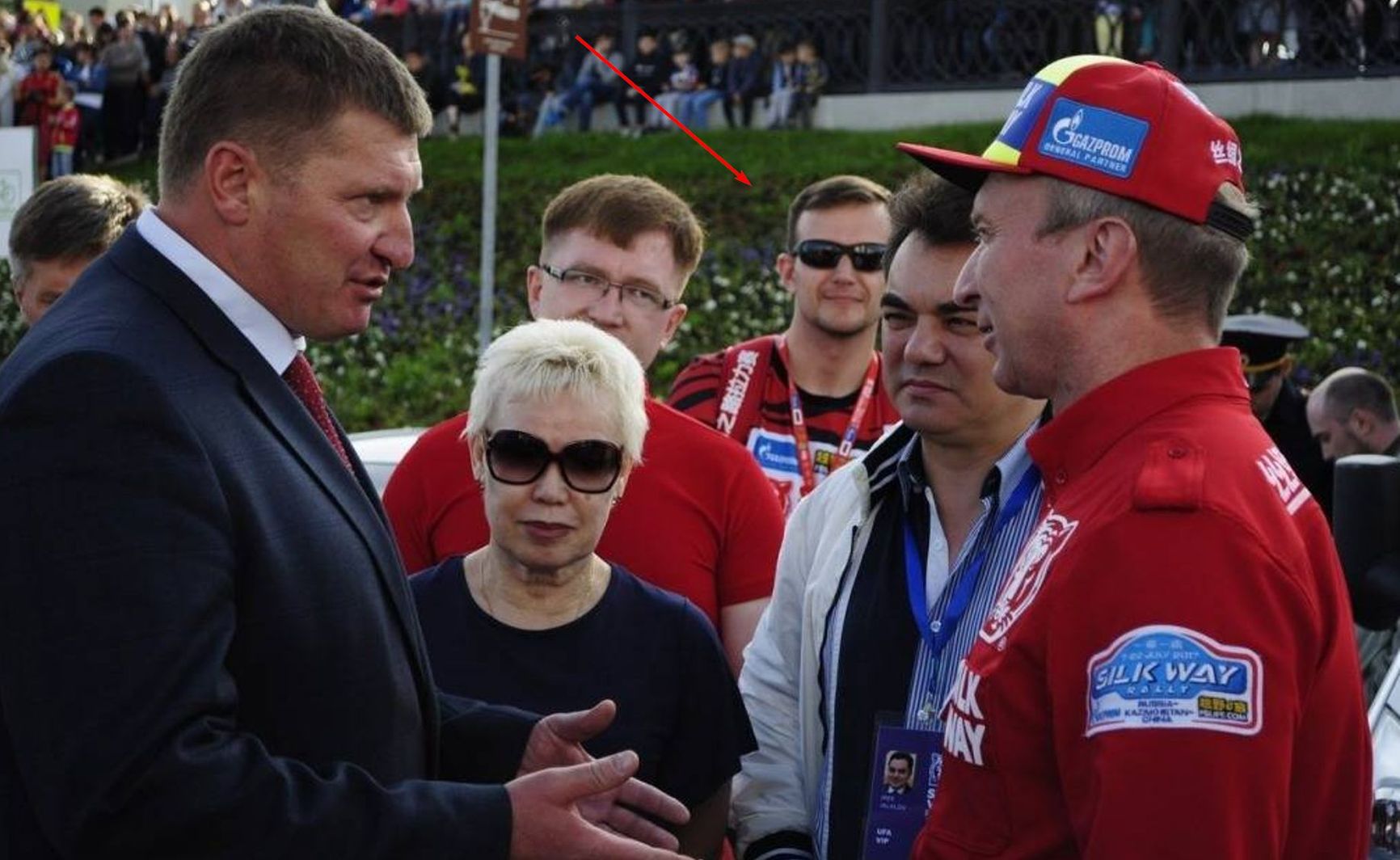 Sergey Avdeenko, a member of Unit 29155,  smiling in the background and disguised as staff at the Silk Way Rally in China in 2017