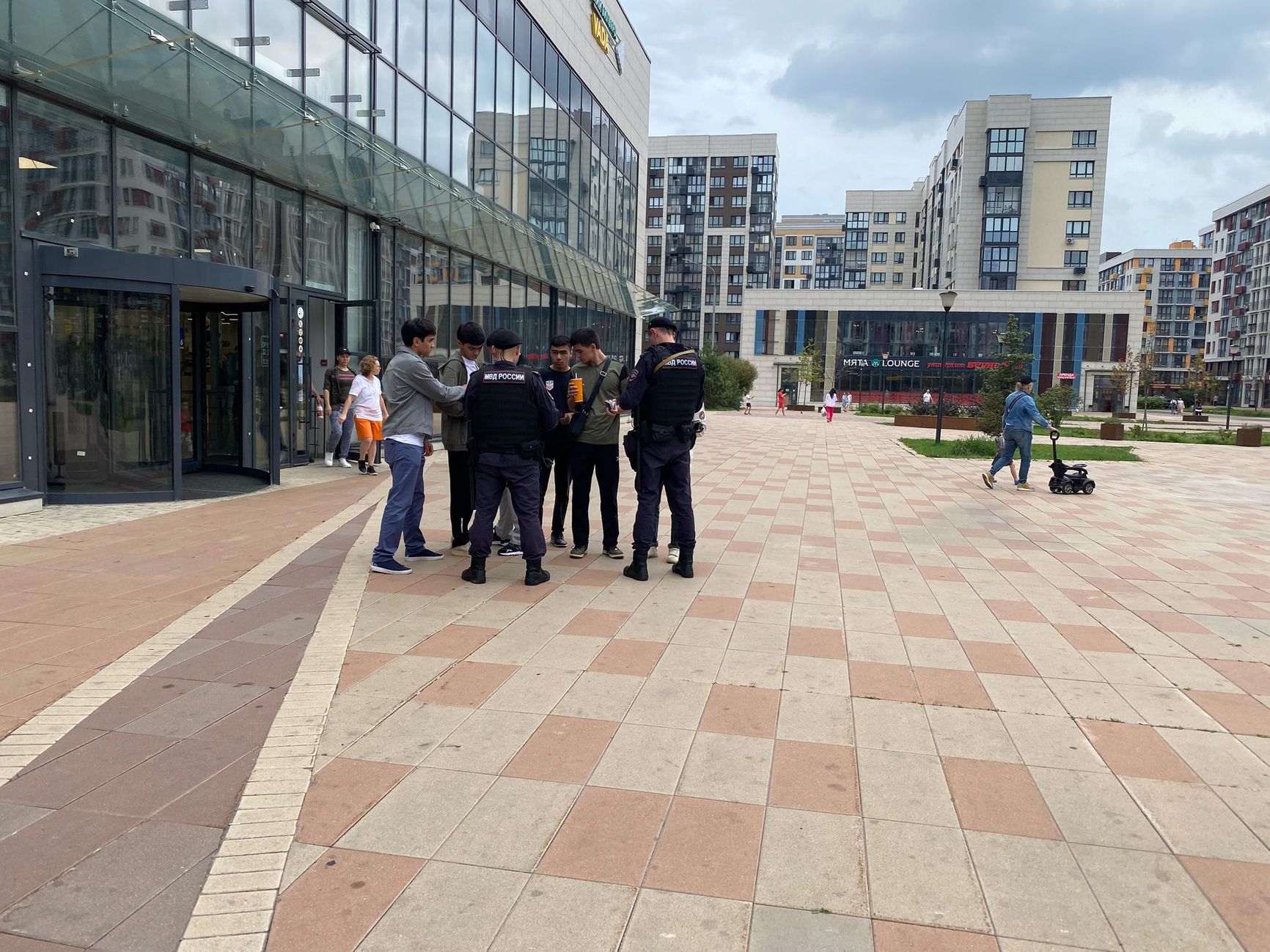 Police officers raiding the streets of a residential compound in New Moscow