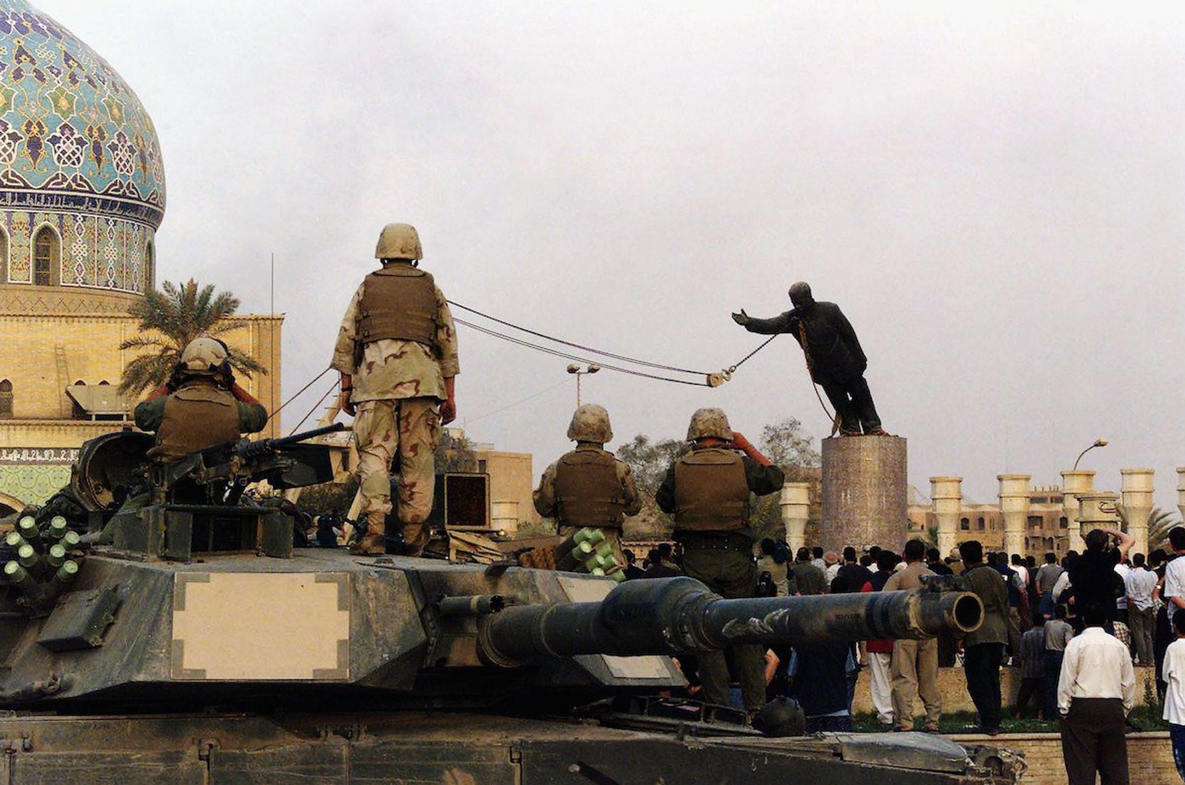 American soldiers watch the demolition of Saddam Hussein's monument in Baghdad, April 9, 2003