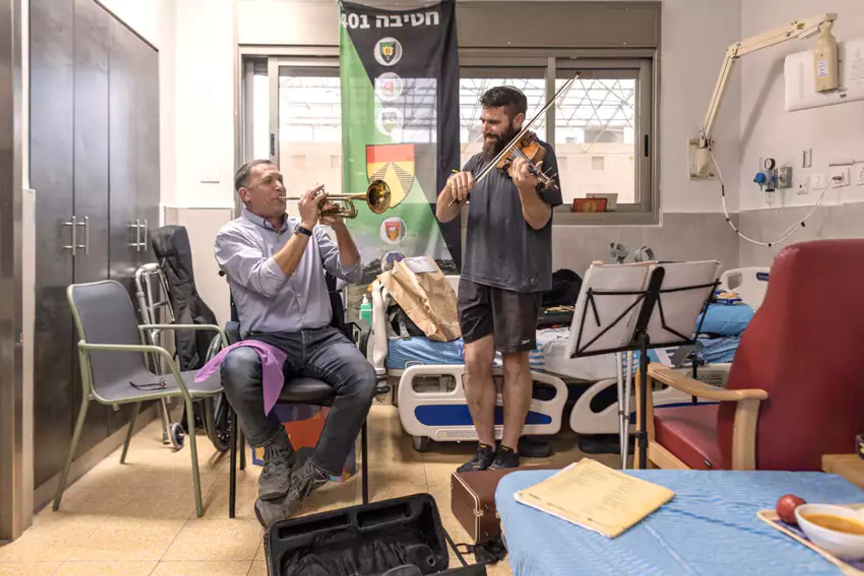 Staff Sergeant Mordechai Shenwald and Knesset member Matan Kahana play music in the rehabilitation department of Sheba Hospital