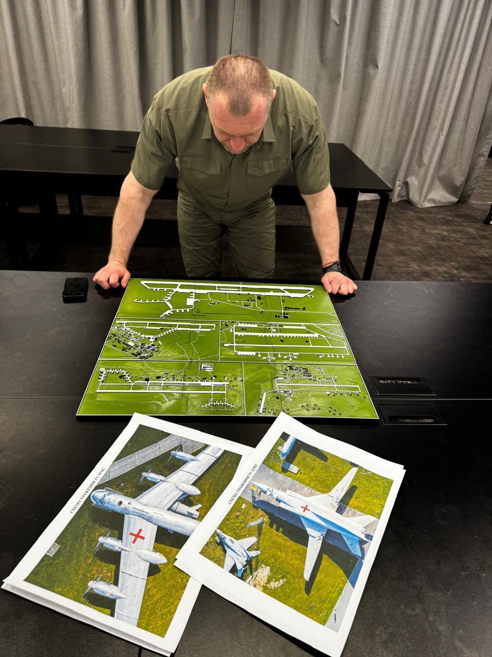 SBU head Vasyl Malyuk looks at maps of the Russian air bases targeted in Operation Spiderweb.
