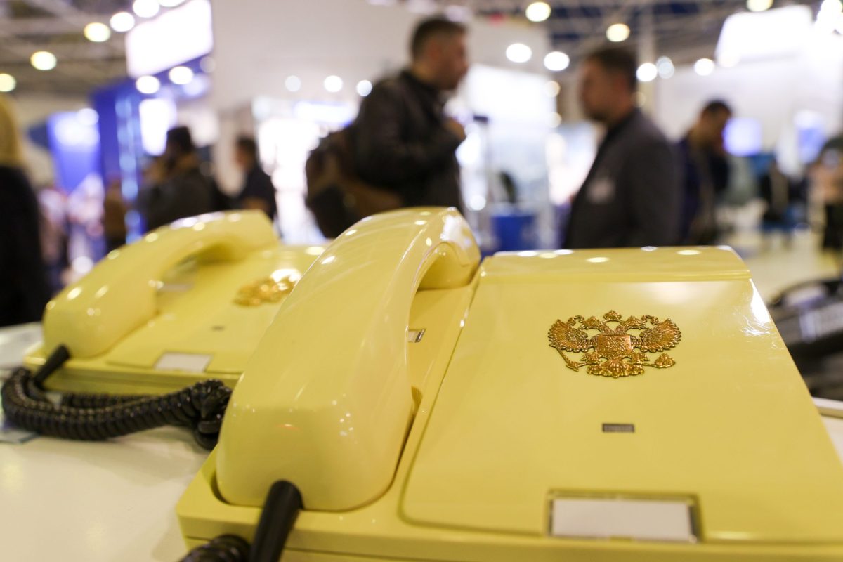 A corded landline telephone bearing the Russian double-headed eagle coat of arms — a secure, government-issued device used by Russian officials on encrypted communication lines. Photo: Sergei Bulkin / NEWS.ru