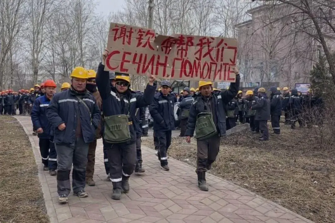 Chinese workers in Komsomolsk-on-Amur hold a placard reading “Sechin. Help,” referring to Rosneft CEO Igor Sechin, whose company owns the refinery where they were employed. Photo: Social media
