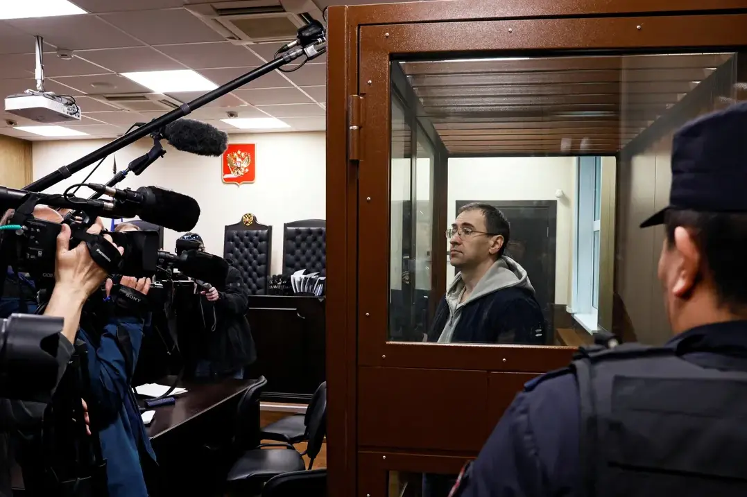 Novaya Gazeta journalist Oleg Roldugin stands in an enclosure for defendants before a court hearing in Moscow, Russia, April 10, 2026. Photo: Reuters